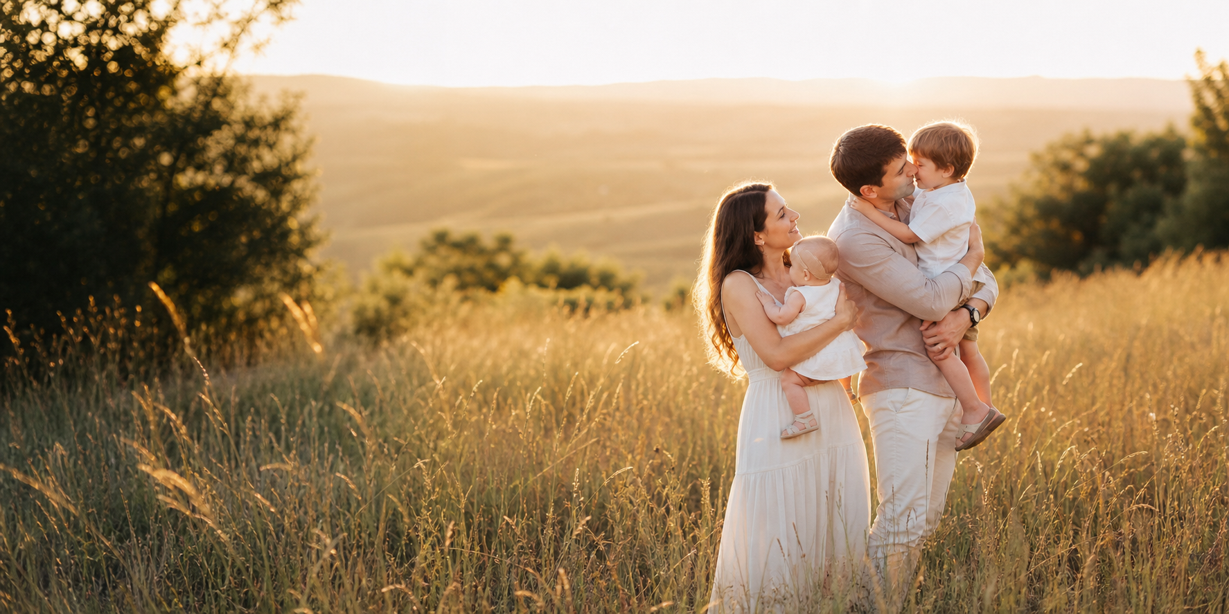 Family sharing a candid moment in a golden meadow.